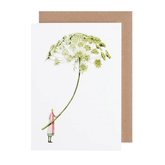 White card with watercolor painting of a small woman holding an oversized ammi flower.