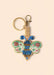 Gold keyring with a beaded blue and mint green bee charm, set against a cream background.