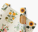 Wrapping paper sheets with botanical illustrations, against a white ackground.