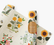 Wrapping paper sheets with botanical illustrations, against a white ackground.