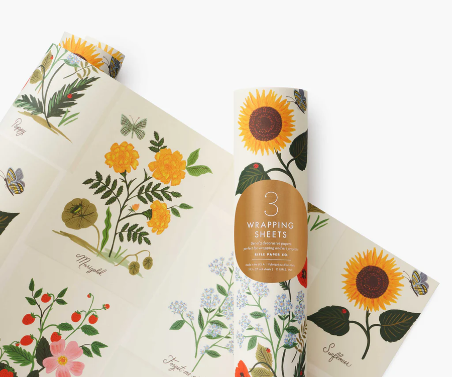 Wrapping paper sheets with botanical illustrations, against a white ackground.
