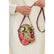 A person wearing a cream-colored dress holds a small, round floral crossbody bag with a purple strap. The bag features a vibrant floral print on a beige background with pink, red, green, and purple flowers.
