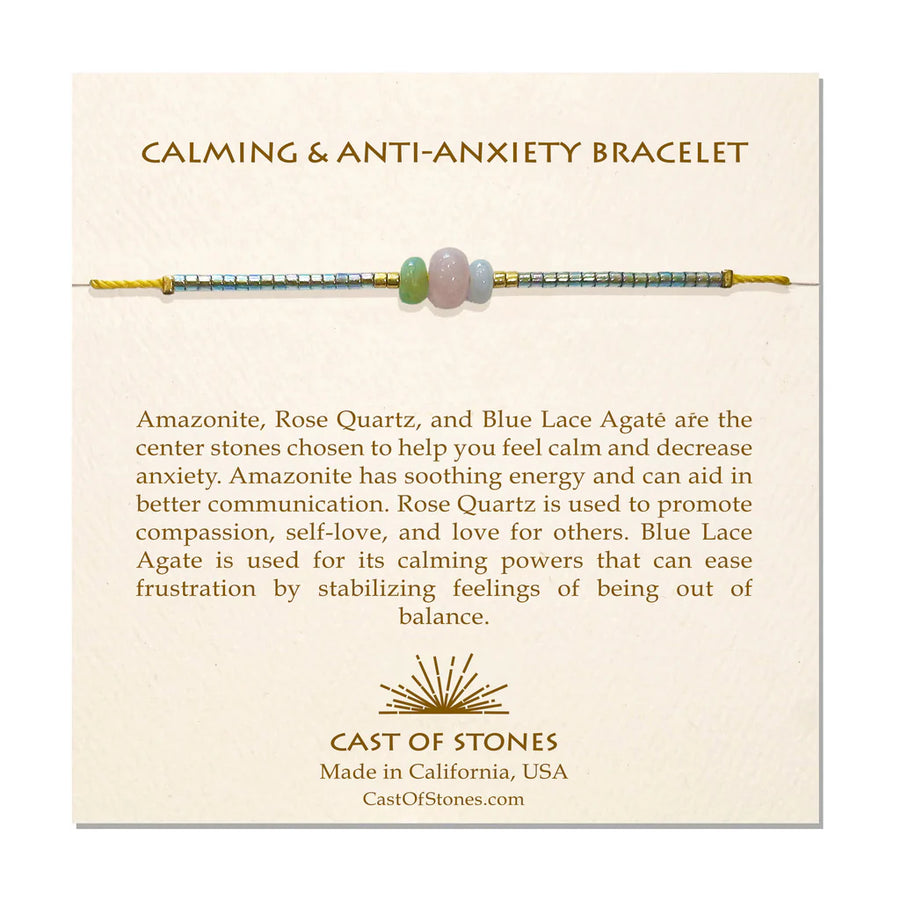 A cream, Cast of Stones branded backing card holds a crystal-beaded bracelet labelled "Calming and Anti-Anxiety Bracelet". There is an informational paragraph below the bracelet detailing the properties of each crystal and its benefits.