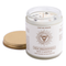 White candle uncapped with crystal chips on the top layer of wax. 