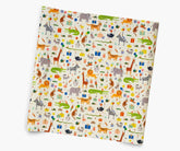 A square sheet of wrapping paper featuring a colorful safari-themed animal print on a cream background, shown at an angle against a plain white background.