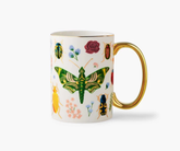 Mug with colorful insect and floral design on a white background