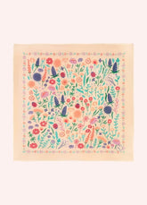 A square cream-colored bandana featuring a dense, colorful wildflower-and-ladybug pattern, displayed flat against a cream background.