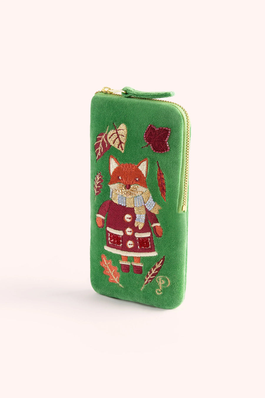 A green zip-around sunglasses case featuring an embroidered fox in a red coat and scarf, surrounded by autumn leaves, on a light cream background.