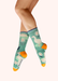 Light jade colored socks with images of ducks, puddles and daisies, against a white background.