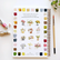Backside of a watercolor workbook displaying each finished page, with a paintbrush to the right and two tubes of paint to the left, against a white background. 