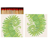 An open matchbook with illustrations of green ferns and matches with red heads poking out of the top. 