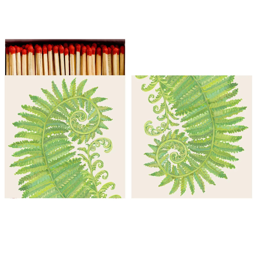 An open matchbook with illustrations of green ferns and matches with red heads poking out of the top. 