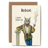 A greeting card with an illustration of a bobcat wearing a gold and black robe, holding a pipe in one hand, and leaning against a white pillar. The text on the card reads "Bobcat. I prefer Robert Cat."