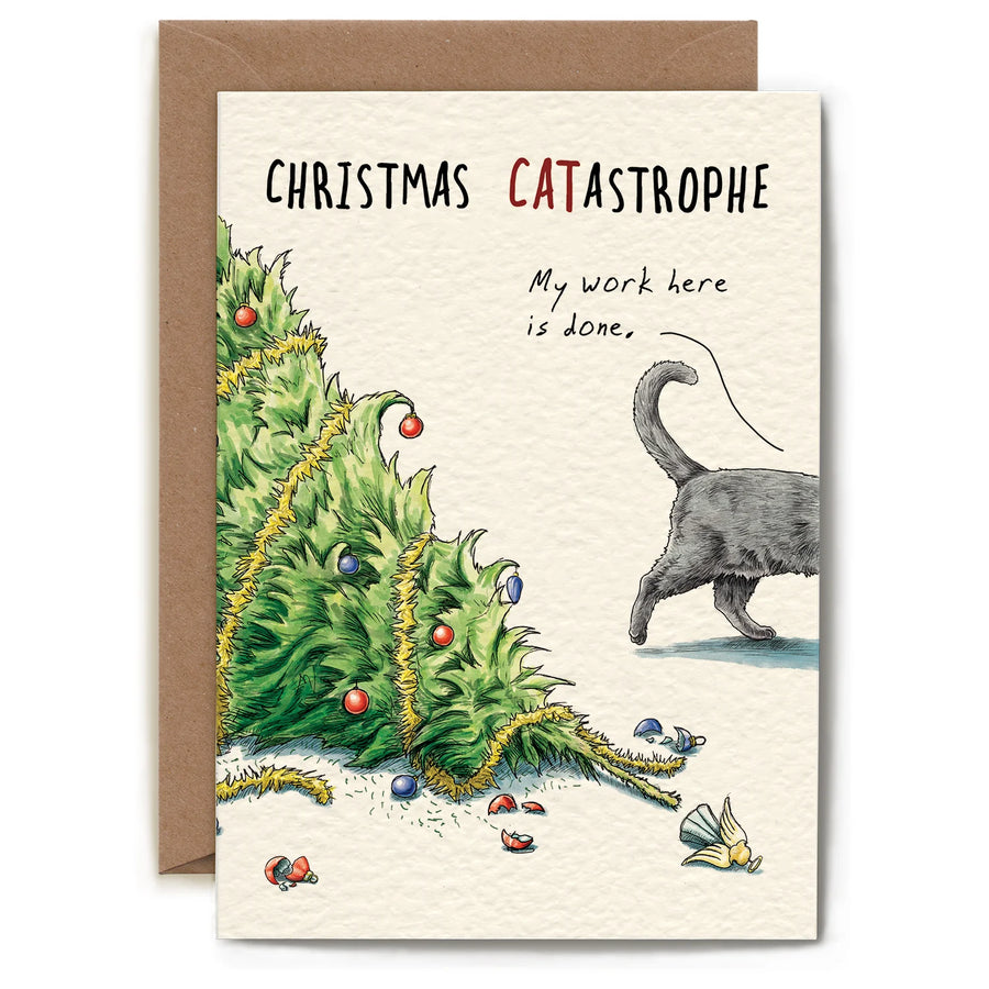 Greeting card with an illustration of the top part of a Christmas tree laying on the ground with bulbs and garland laying around it. The back half of a grey cat walks off on the right side, and the card reads "Christmas Catastrophe", with a speech bubble above the cat that says "my work here is done".