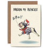 Greeting card with an illustration of a black and white french bulldog wearing a black and white striped shirt, and a red beret and scarf. A text bubble above the dog has a censored explitive and the text on the card reads "Pardon my frenchie".