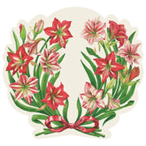 Die-cut placemat with red, and red and white amaryllis flowers in a grecian wreath shape. There is a red bow in the bottom middle, tying the two sides together.