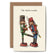 Greeting card with two nutcrackers standing across from the other, the one on the left kicking the other in the nether regions. The card reads "The Nutcracker".
