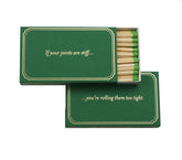 Green matchbox with the saying "If your joints are stiff...you're rolling them too tight."