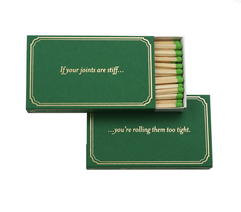 Green matchbox with the saying "If your joints are stiff...you're rolling them too tight."