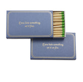 A dark blue matchbook with the saying "If you love something, set it free. If you hate something, set it on fire."