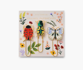 Set of decorative paper clips shaped like a ladybug, frog, and butterfly on a Rifle Paper Co.-branded card.