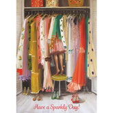 A painting of a closet filled with colorful dresses. A stool sits in the front center, and a girl can be seen standing on the stool, the top half of her body in the closet among the clothes. Five pairs of shoes sit on the floor, and red cursive text at the bottom reads "Have a Sparkly Day!"