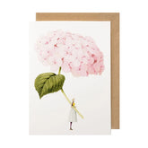 White card with a watercolor painting of a small woman holding an oversized pink hydrangea.