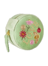A light green velvet round jewelry box with embroidered flowers, a bee, and the word 'LOVE' on the front, featuring a side strap and a gold zipper.