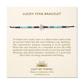 A cream, Cast of Stones-branded backing card holds a crystal-beaded bracelet labelled "Lucky Star Bracelet". There is an informational paragraph below the bracelet.