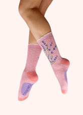 Light pink socks with an image of a sprig of lavender, against a white background.