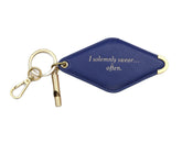 A navy blue diamond-shaped leather keychain with a brass key ring, split ring, and whistle. Engraved on the keychain is the phrase "I solemnly swear...often."