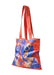 A red canvas tote bag with long red shoulder straps, featuring a blue-and-beige printed pattern of two King Charles Spaniels on the front, set against a plain white background.