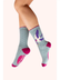 A light blue and magenta pair of socks with a blue and indigo swallow pattern, against a white background. 