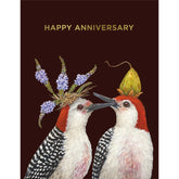 Two woodpeckers sit facing each other with flowers on their heads. Gold text above them reads "Happy Anniversary!" 